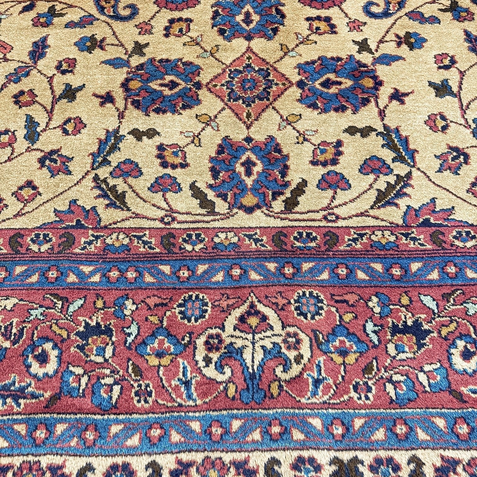 Close view of a Turkish Oushak rug showing floral pile and border details