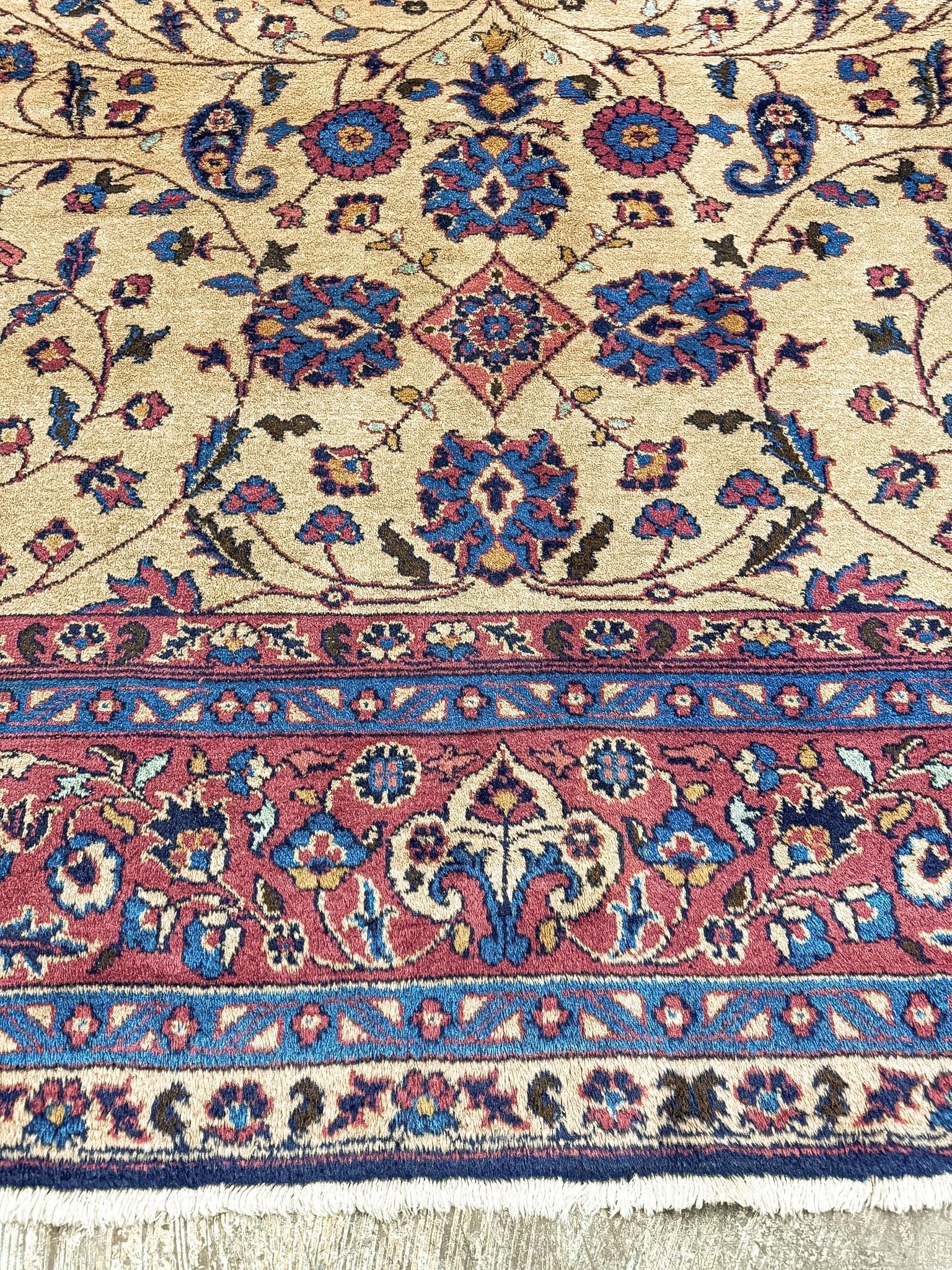 Close view of a Turkish Oushak rug showing floral pile and border details