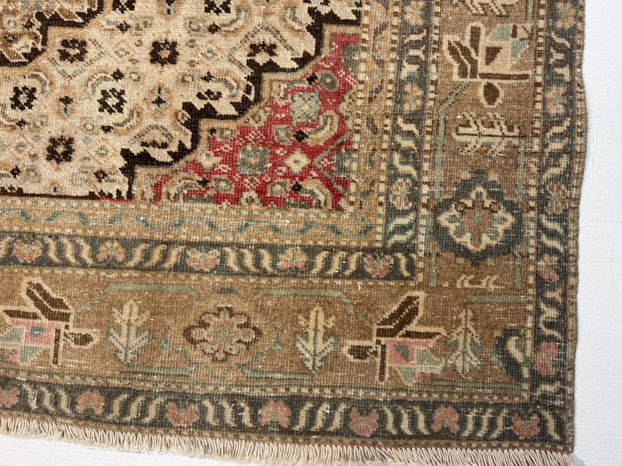 Close view of an Ardabil rug border showing pile texture and colour variation