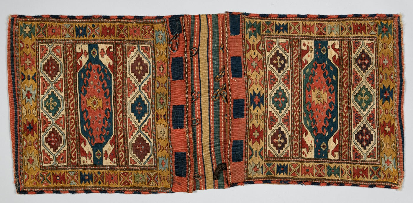 Shahsevan double saddlebag with two patterned pockets, a striped bridge and braided closures