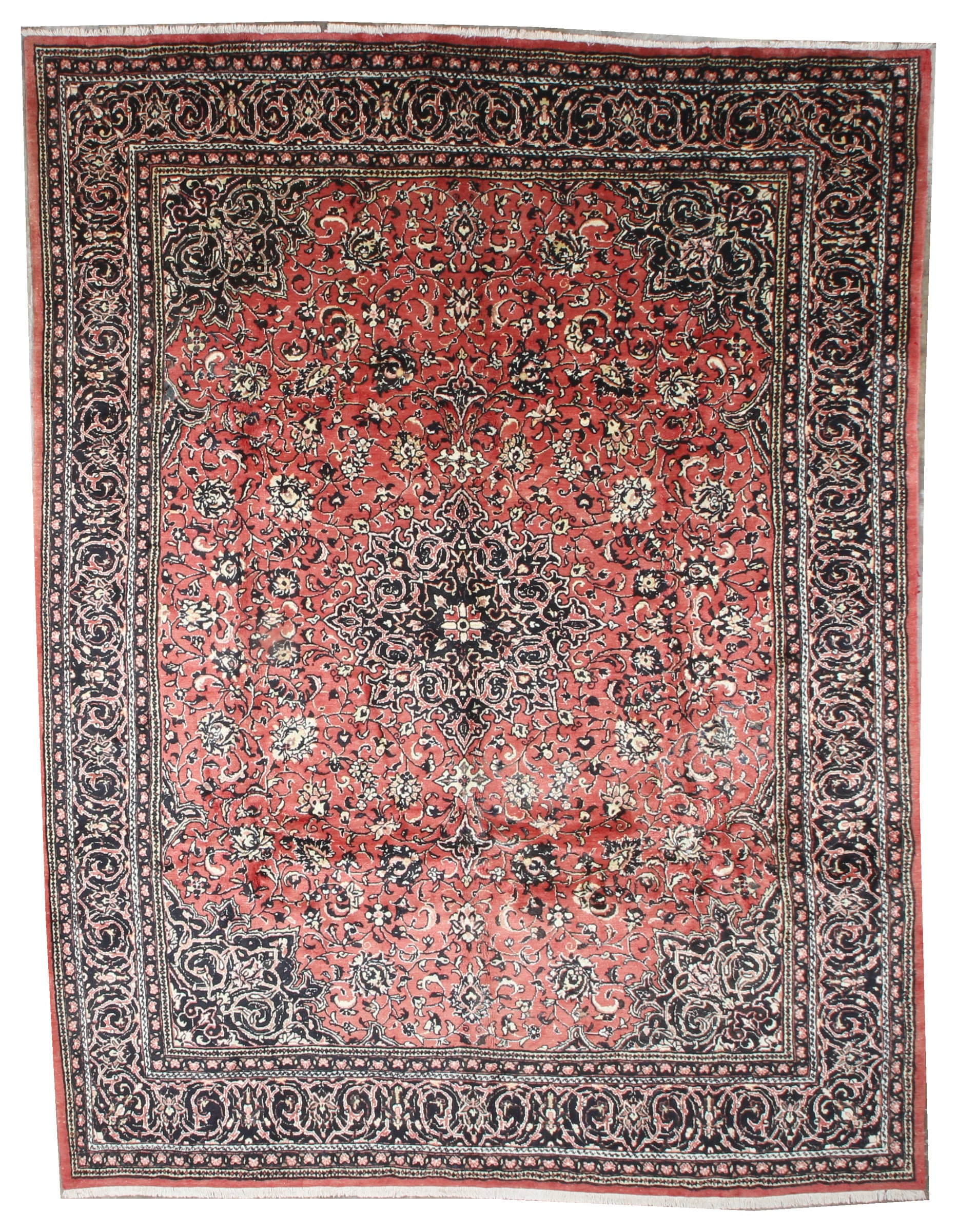 Sarough hand-knotted wool rug, top view on white, showing a red floral field with a central medallion and dark navy border.