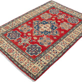 Full view at an angle of red & blue Kazak-inspired wool rug 15499.