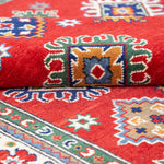 Folded edge and wool pile of red & blue Kazak-inspired wool rug 21414.