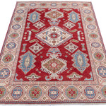 Full view from a low angle of red & blue Kazak-inspired wool rug 21422.