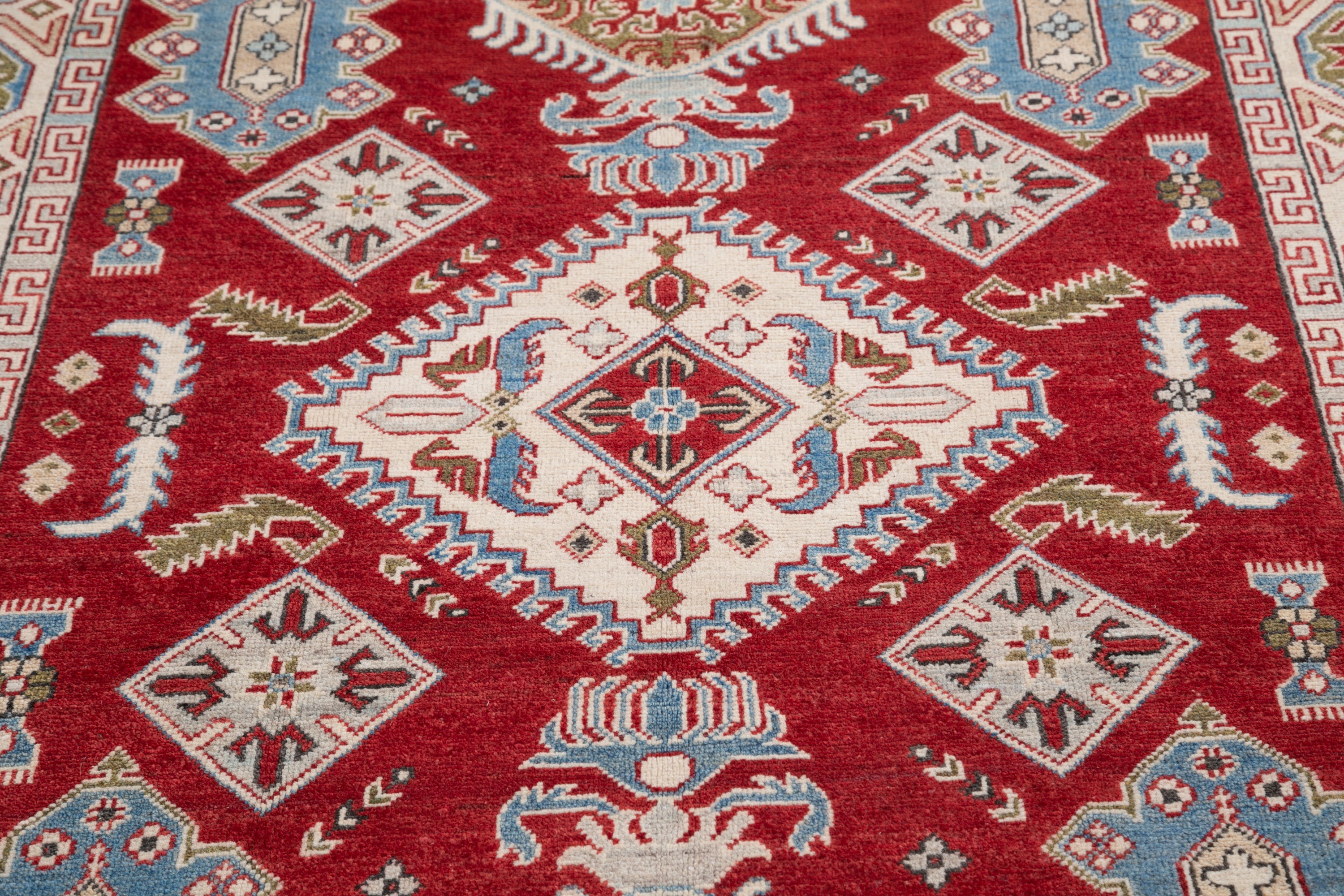 Pattern detail of red & blue Kazak-inspired wool rug 21422.