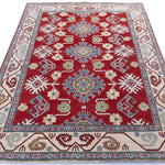 Full view from a low angle of red & blue Kazak-inspired wool rug 21423.