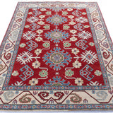 Full view from a low angle of red & blue Kazak-inspired wool rug 21423.