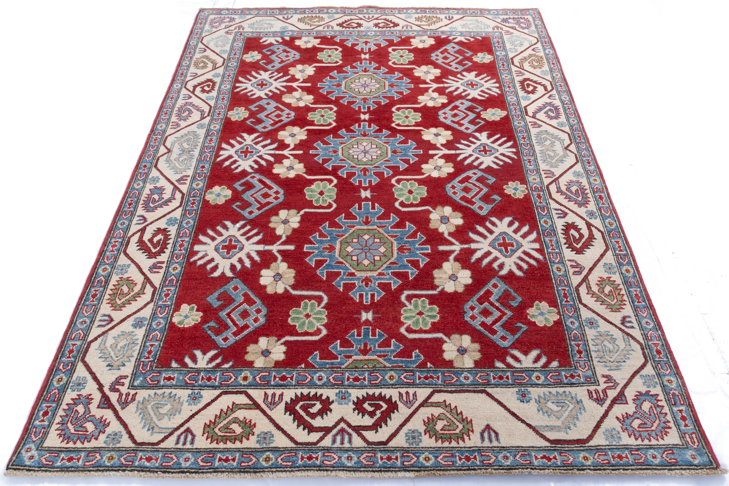 Full view from a low angle of red & blue Kazak-inspired wool rug 21423.