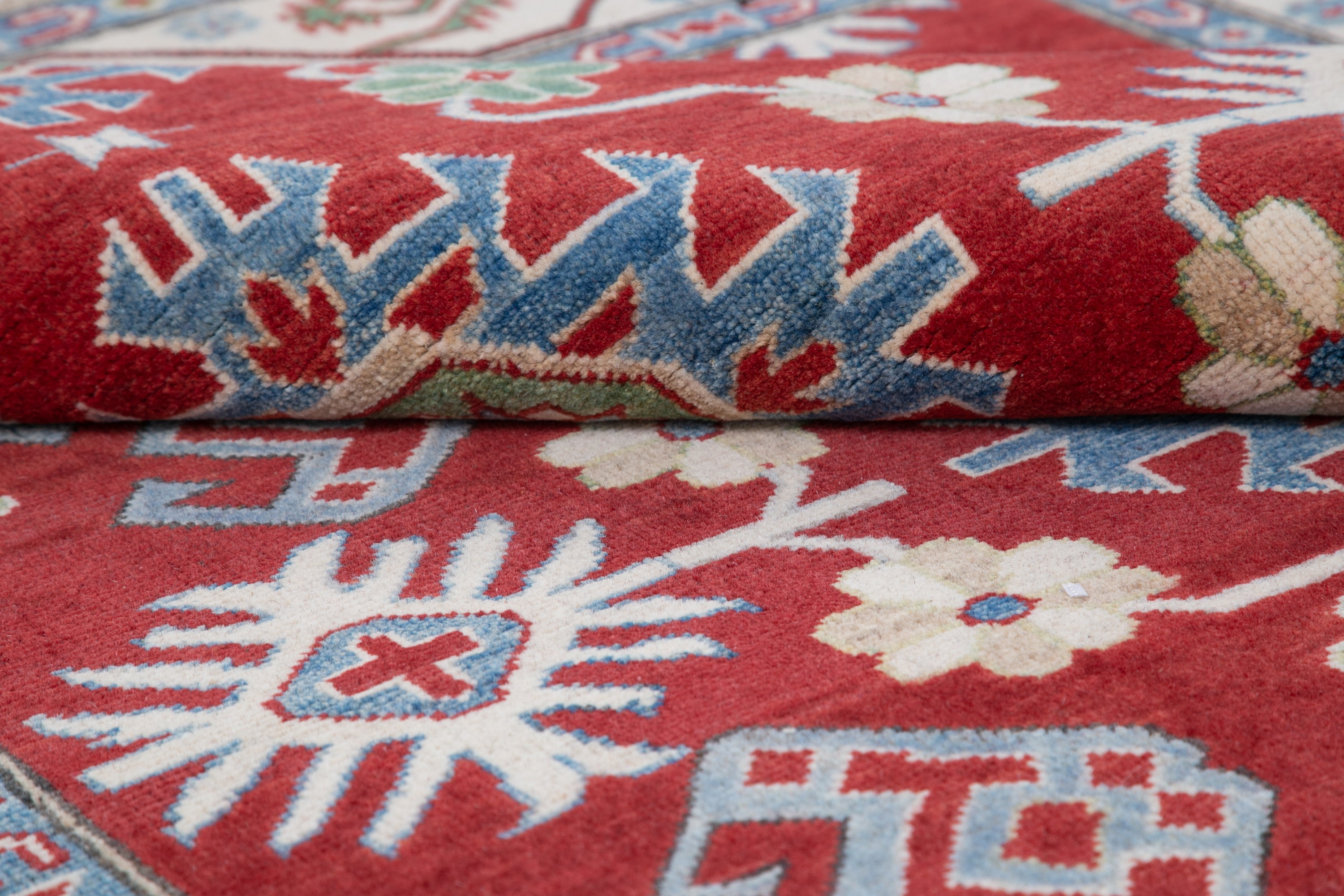 Folded edge and wool pile of red & blue Kazak-inspired wool rug 21423.