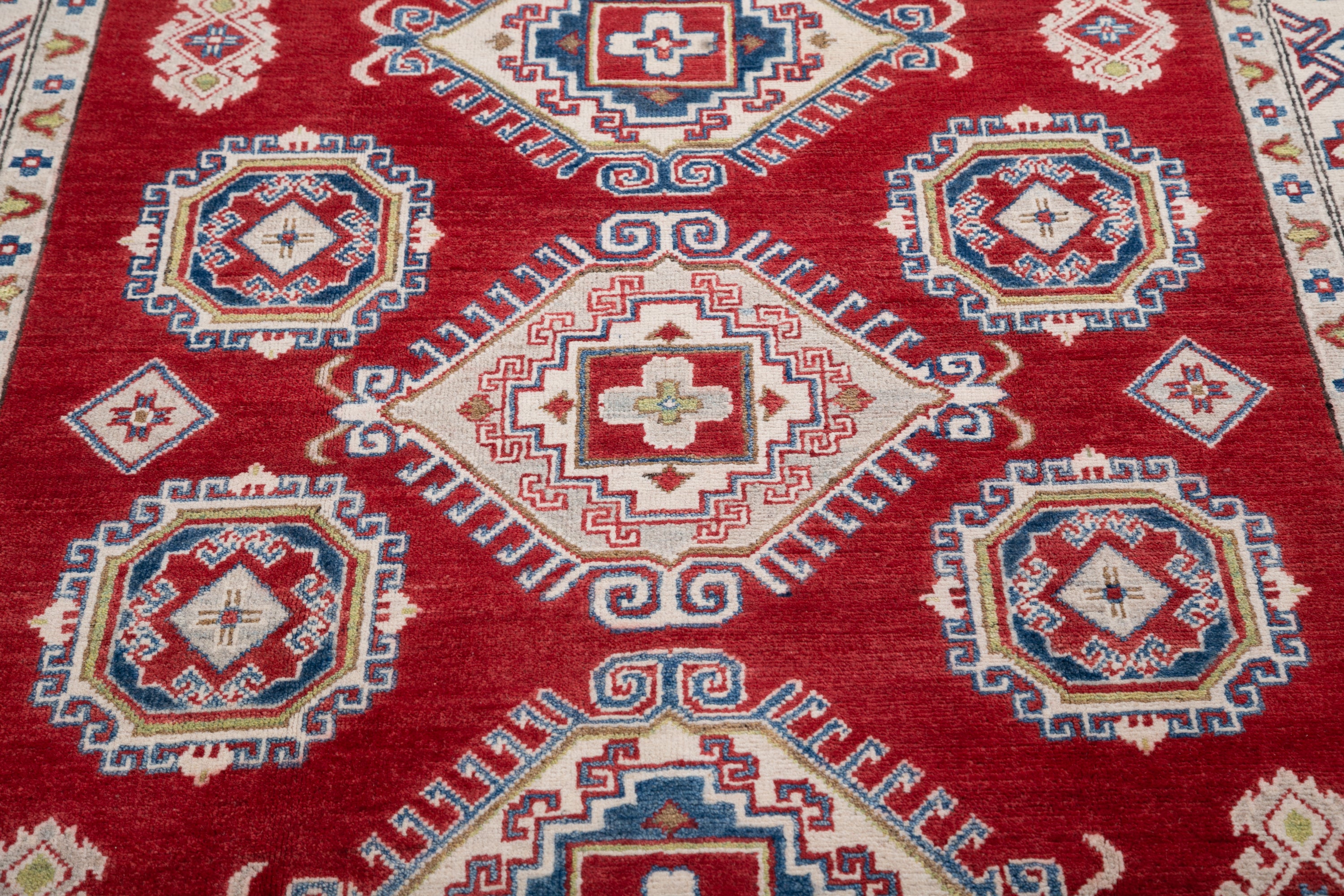 Pattern detail of red & ivory Kazak-inspired wool rug 21424.