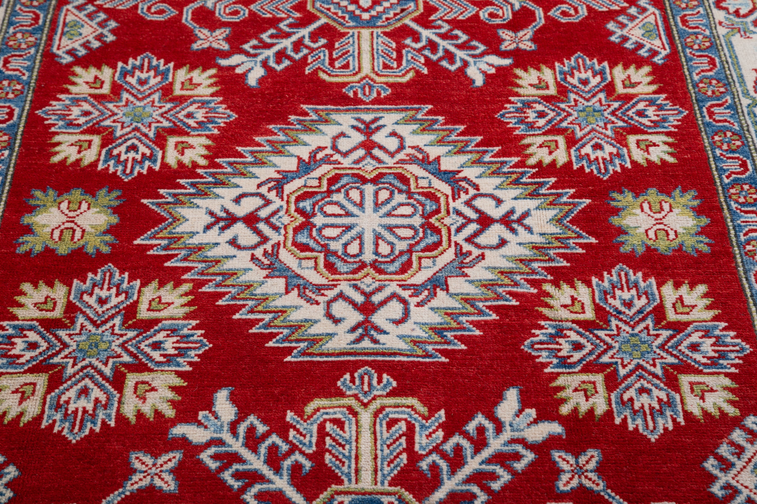 Pattern detail of red & blue Kazak-inspired wool rug 21425.