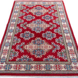 Full view from a low angle of red & blue Kazak-inspired wool rug 21434.