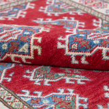Folded edge and wool pile of red & blue Kazak-inspired wool rug 21434.