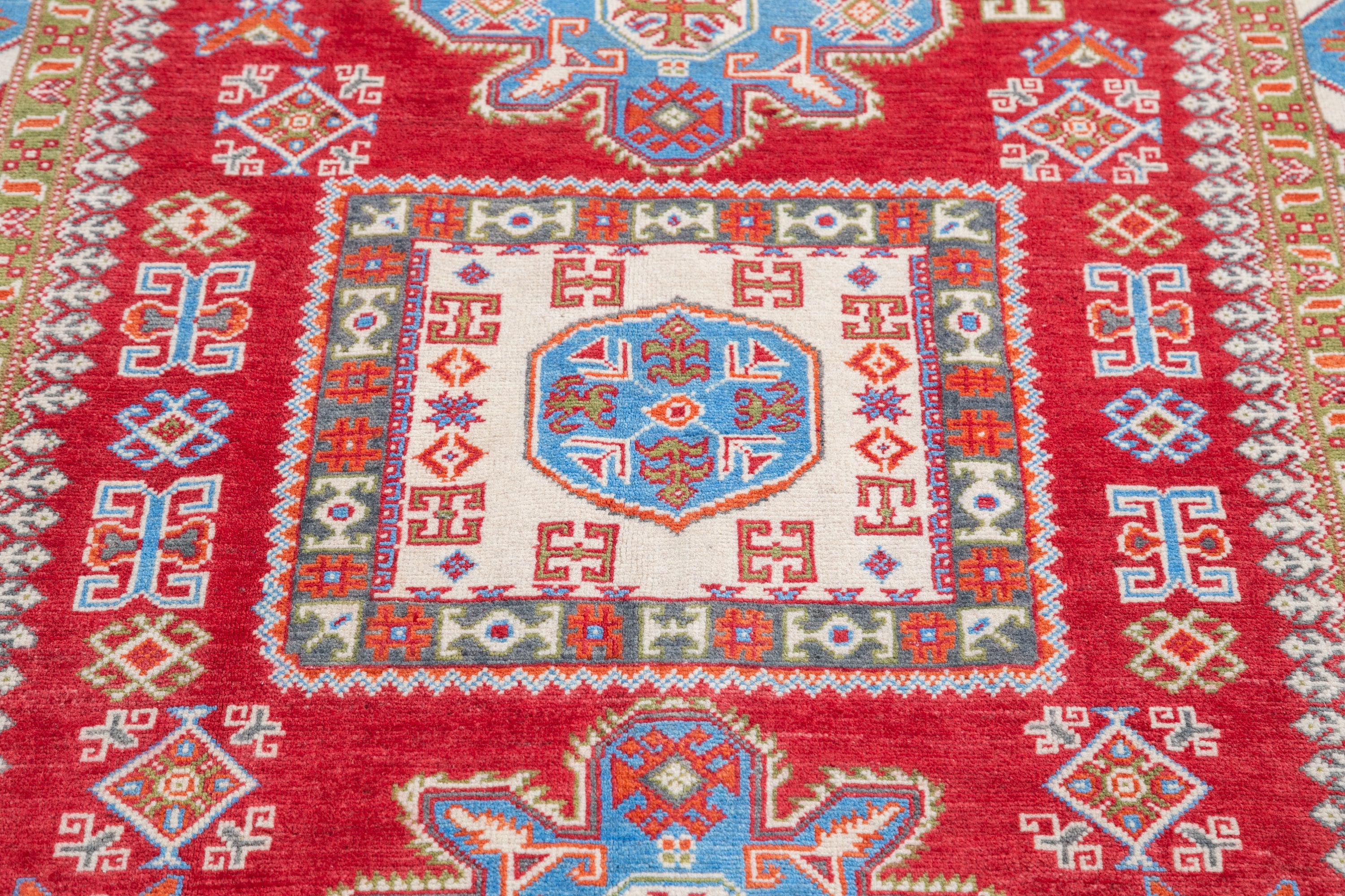 Pattern detail of red & blue Kazak-inspired wool rug 21474.