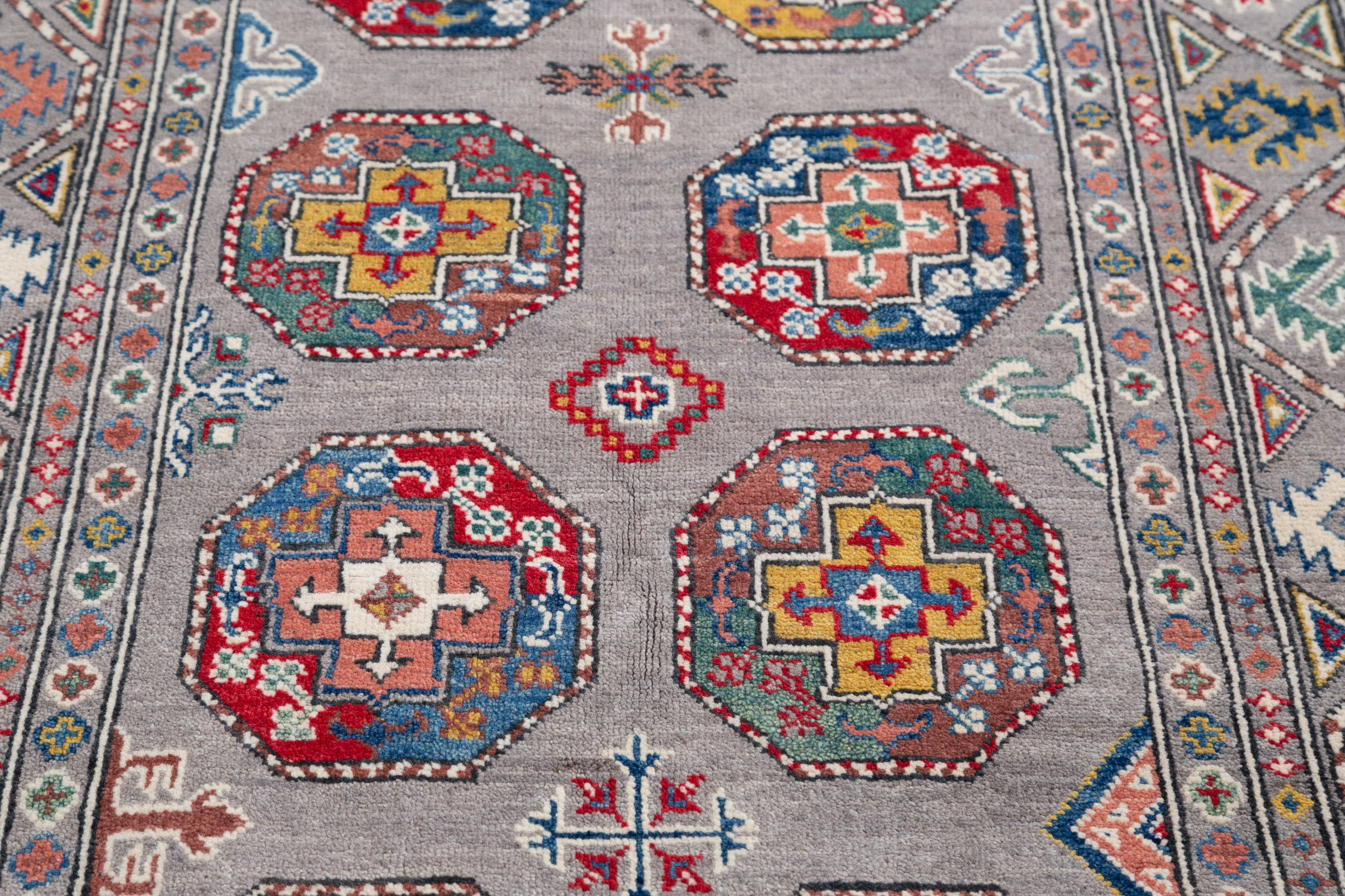 Pattern detail of blue & red Kazak-inspired wool rug 21479.