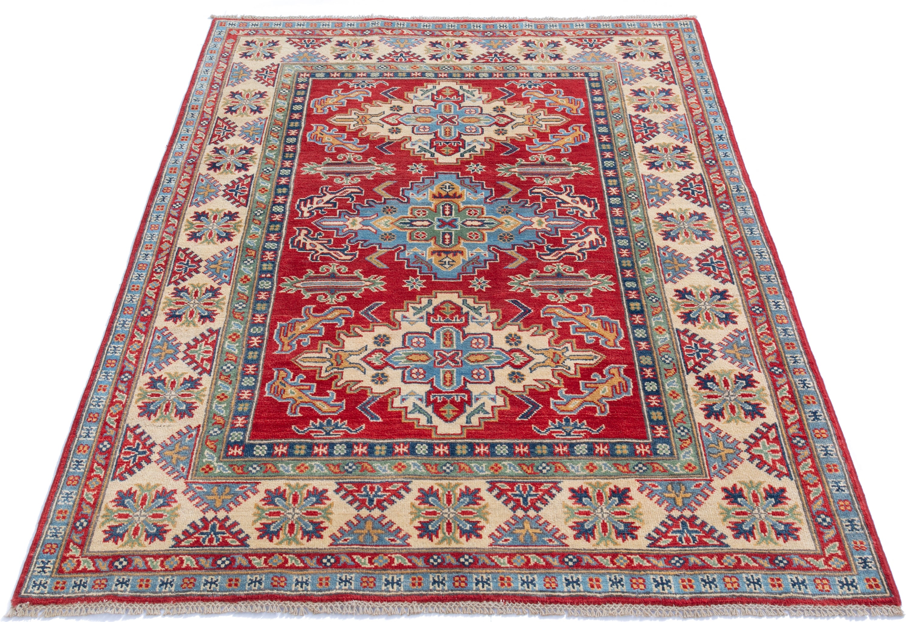 Full view from a low angle of red & green Kazak-inspired wool rug 21525.