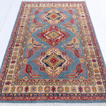 Full view from a low angle of blue & red Kazak-inspired wool rug 21980.