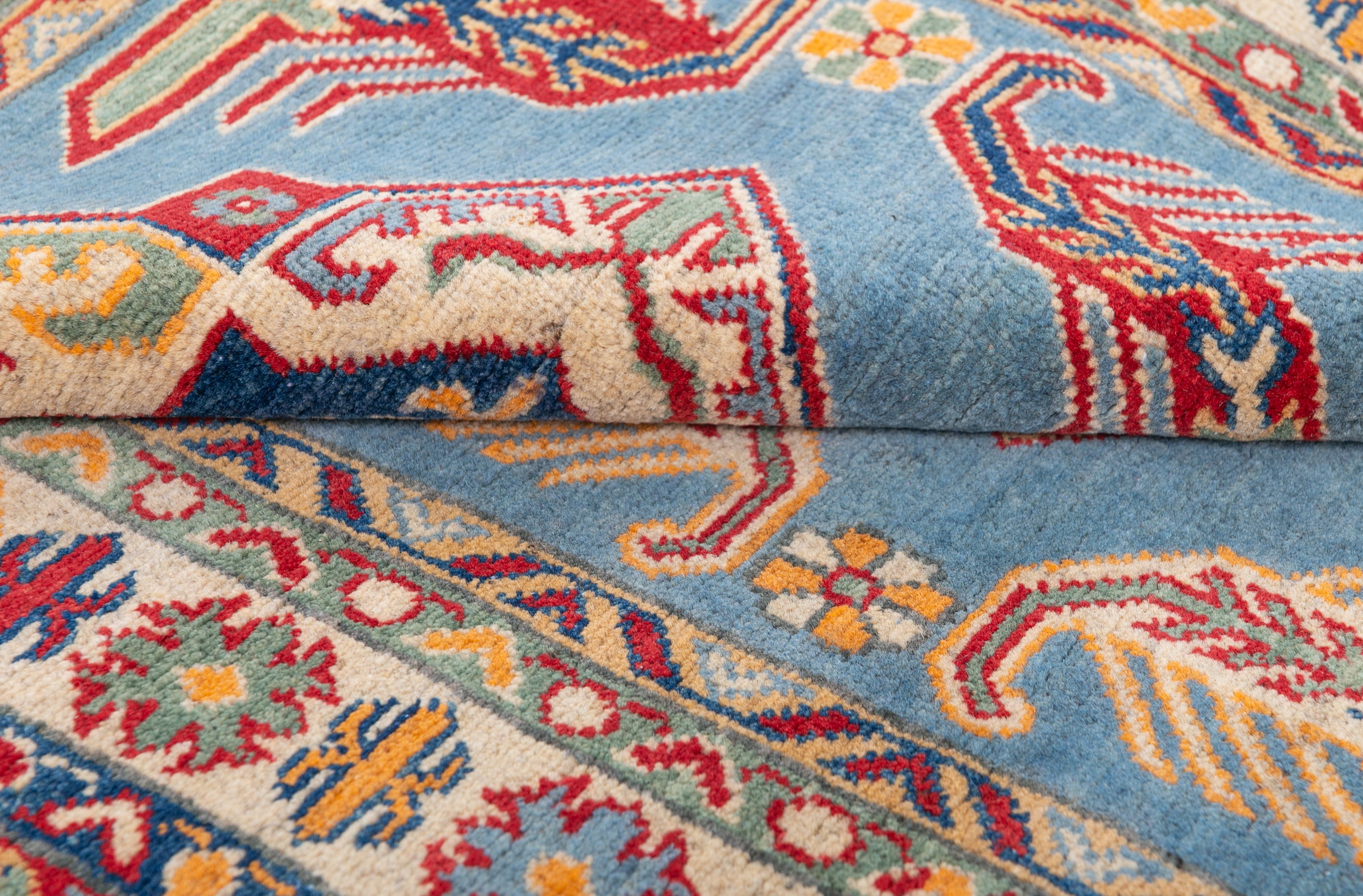 Folded edge and wool pile of blue & red Kazak-inspired wool rug 21980.