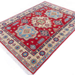 Full view at an angle of red & blue Kazak-inspired wool rug 21982.