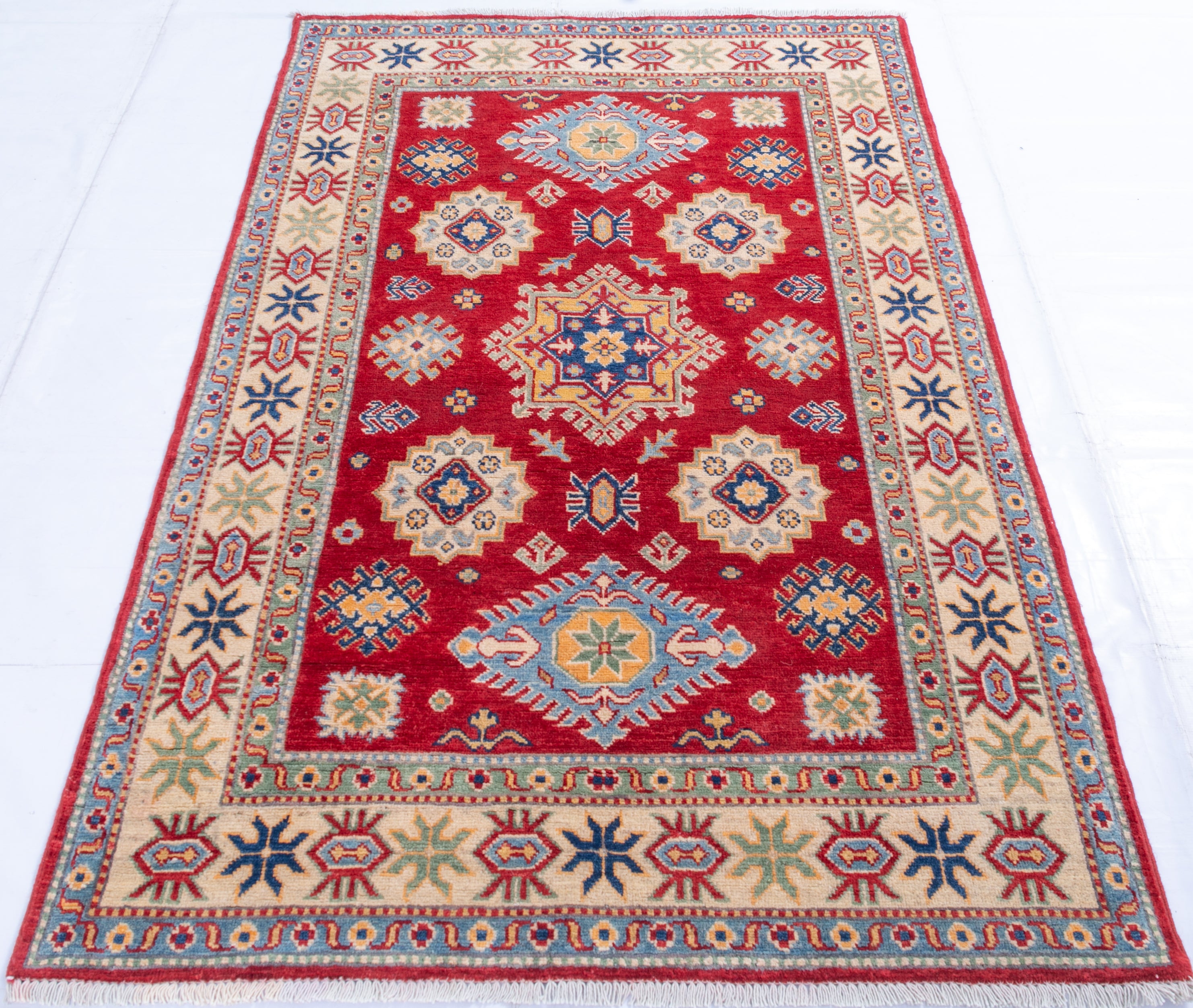 Full view from a low angle of red & ivory Kazak-inspired wool rug 21984.