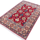 Full view at an angle of red & ivory Kazak-inspired wool rug 21997.