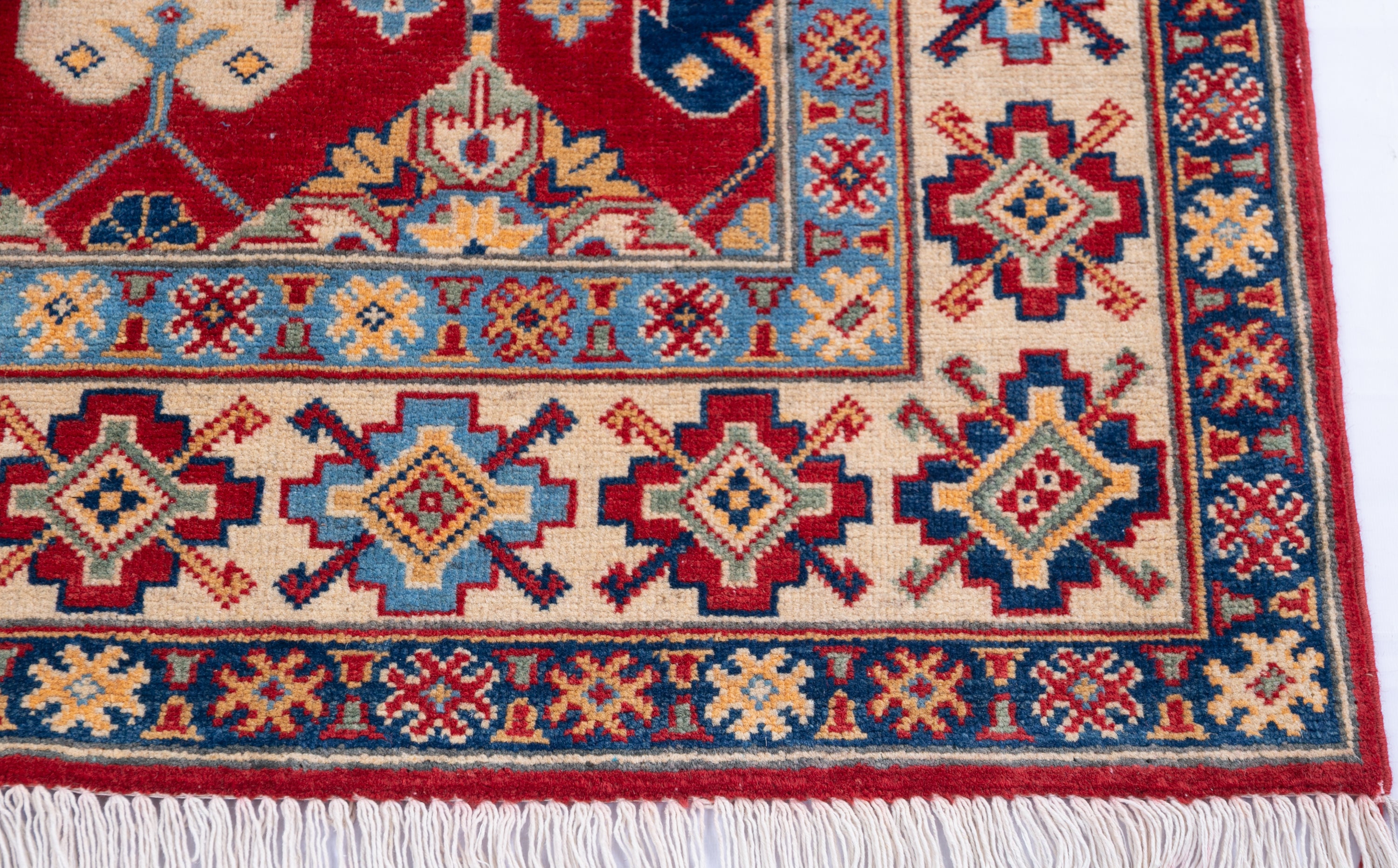 Border and edge detail of red & ivory Kazak-inspired wool rug 21997.