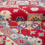 Folded edge and wool pile of red & ivory Kazak-inspired wool rug 21997.