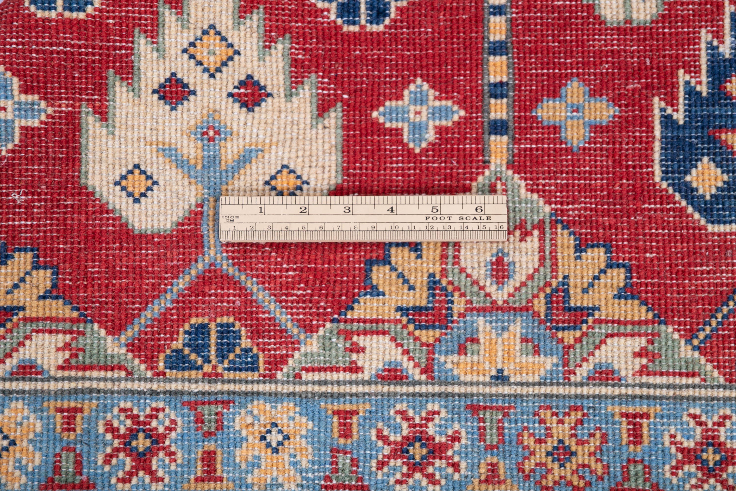 Wool pile close-up of red & ivory Kazak-inspired wool rug 21997.