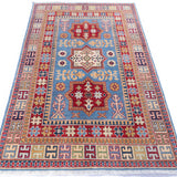 Full view from a low angle of blue & red Kazak-inspired wool rug 22077.