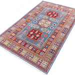 Full view at an angle of blue & red Kazak-inspired wool rug 22077.