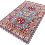 Full view at an angle of blue & red Kazak-inspired wool rug 22077.