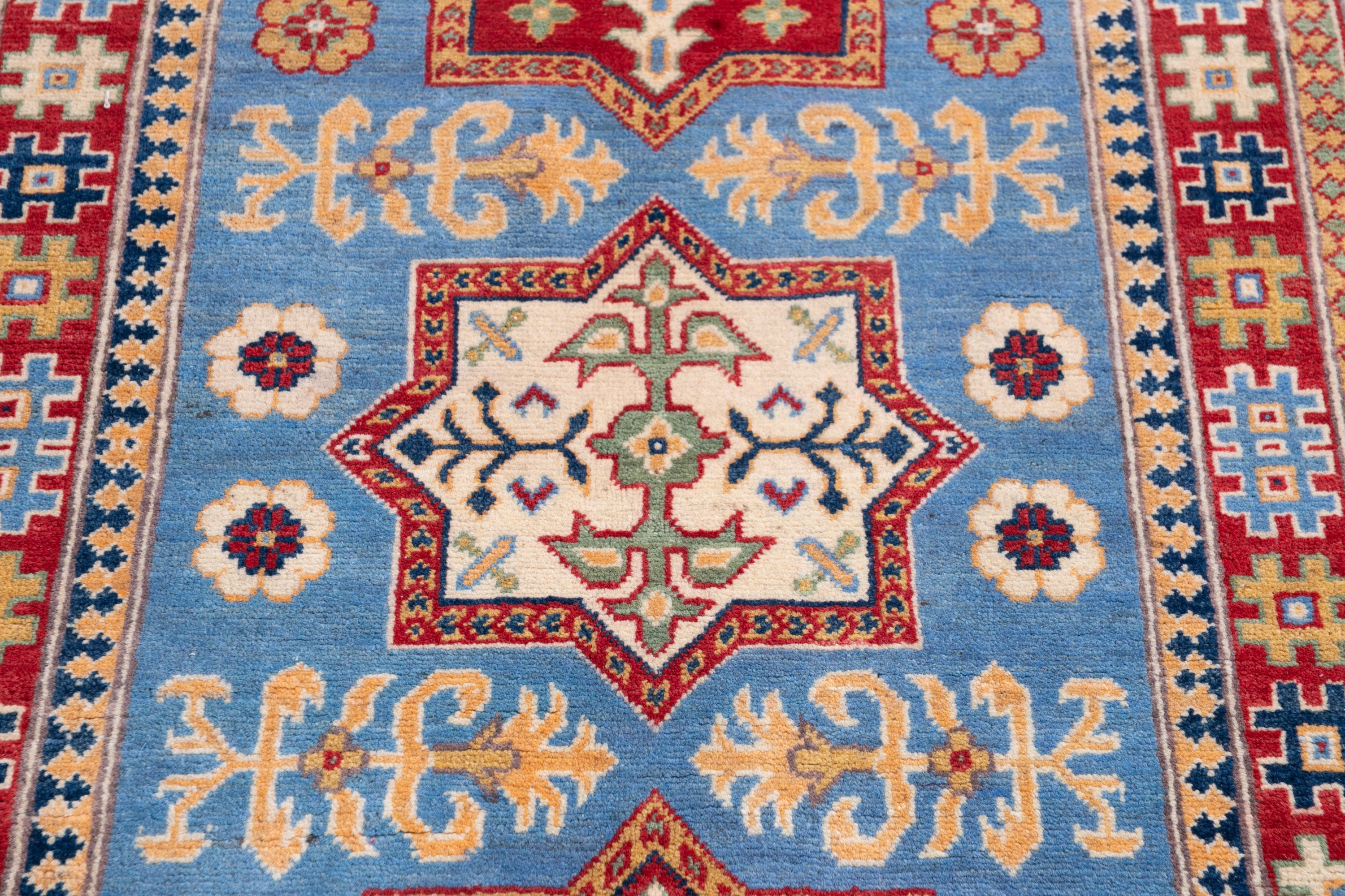 Pattern detail of blue & red Kazak-inspired wool rug 22077.