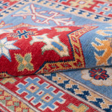 Folded edge and wool pile of blue & red Kazak-inspired wool rug 22077.