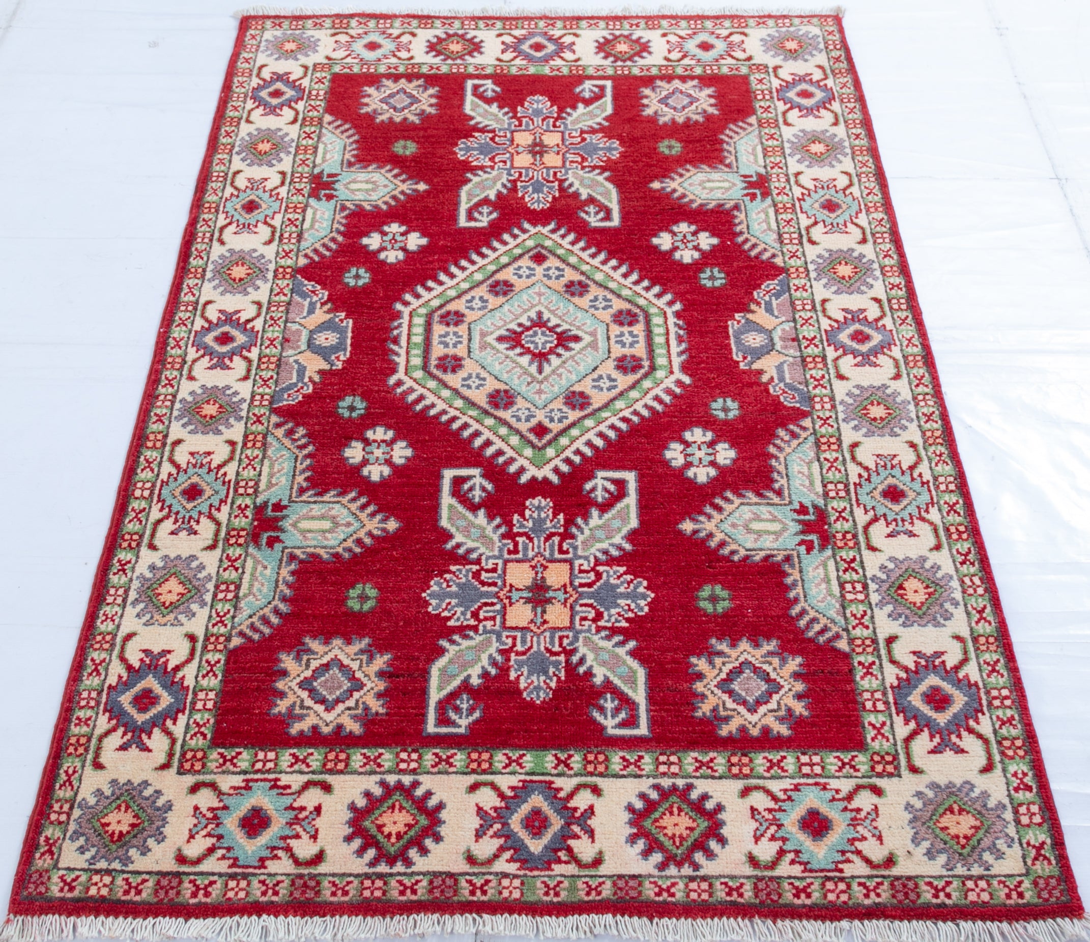 Full view from a low angle of red & ivory Kazak-inspired wool rug 23375.