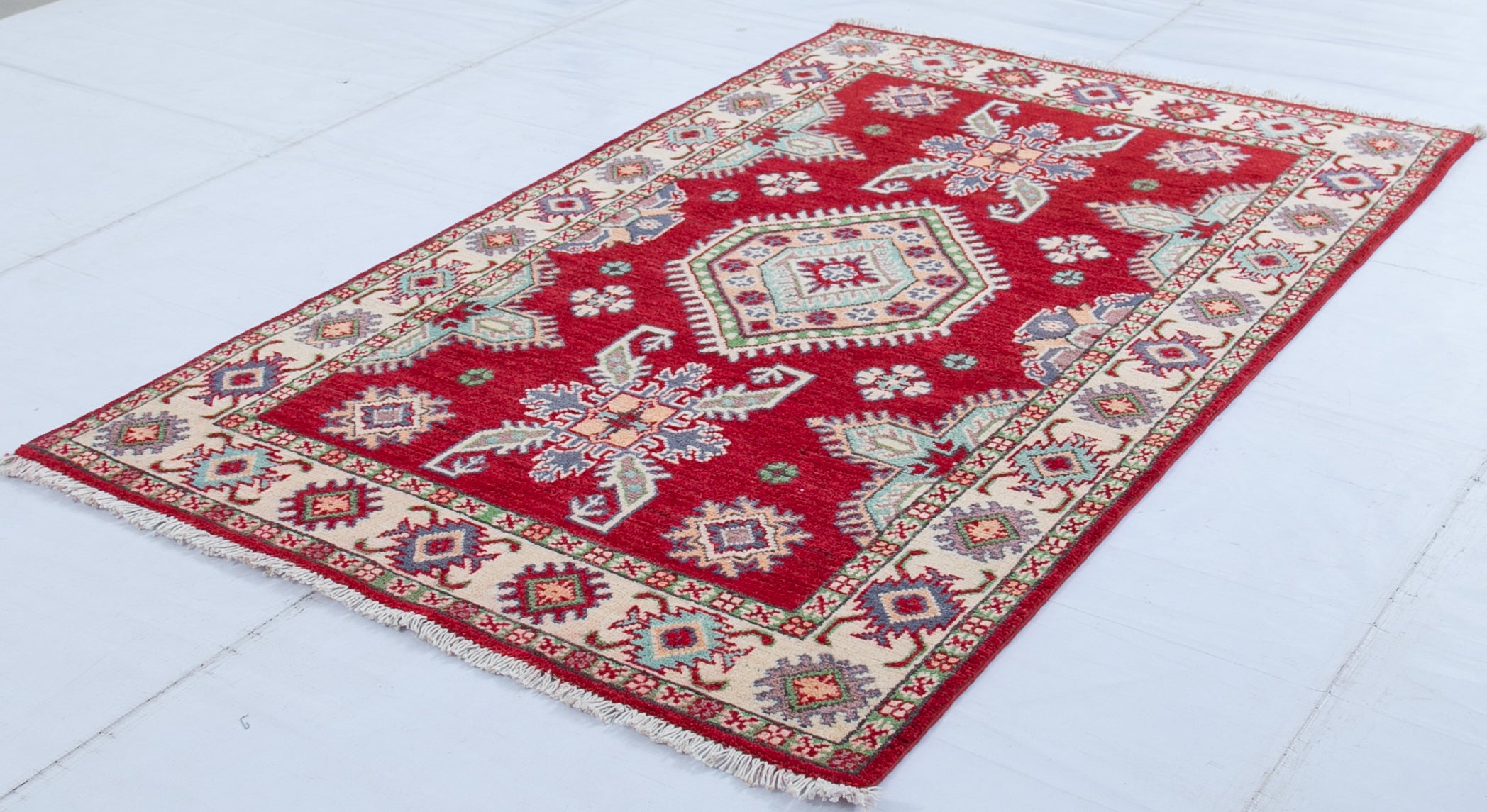 Full view at an angle of red & ivory Kazak-inspired wool rug 23375.