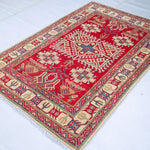 Full view at an angle of red & ivory Kazak-inspired wool rug 23925.