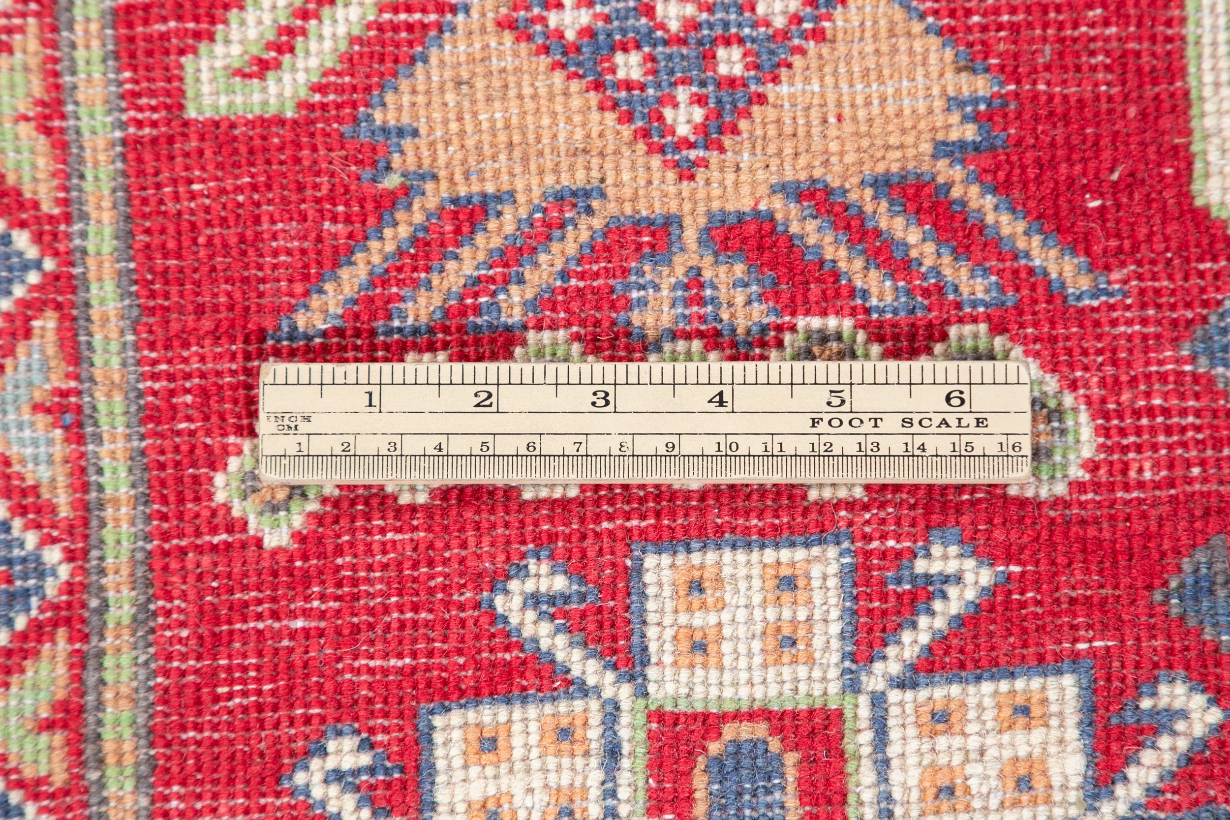Wool pile close-up of red & ivory Kazak-inspired wool rug 23925.