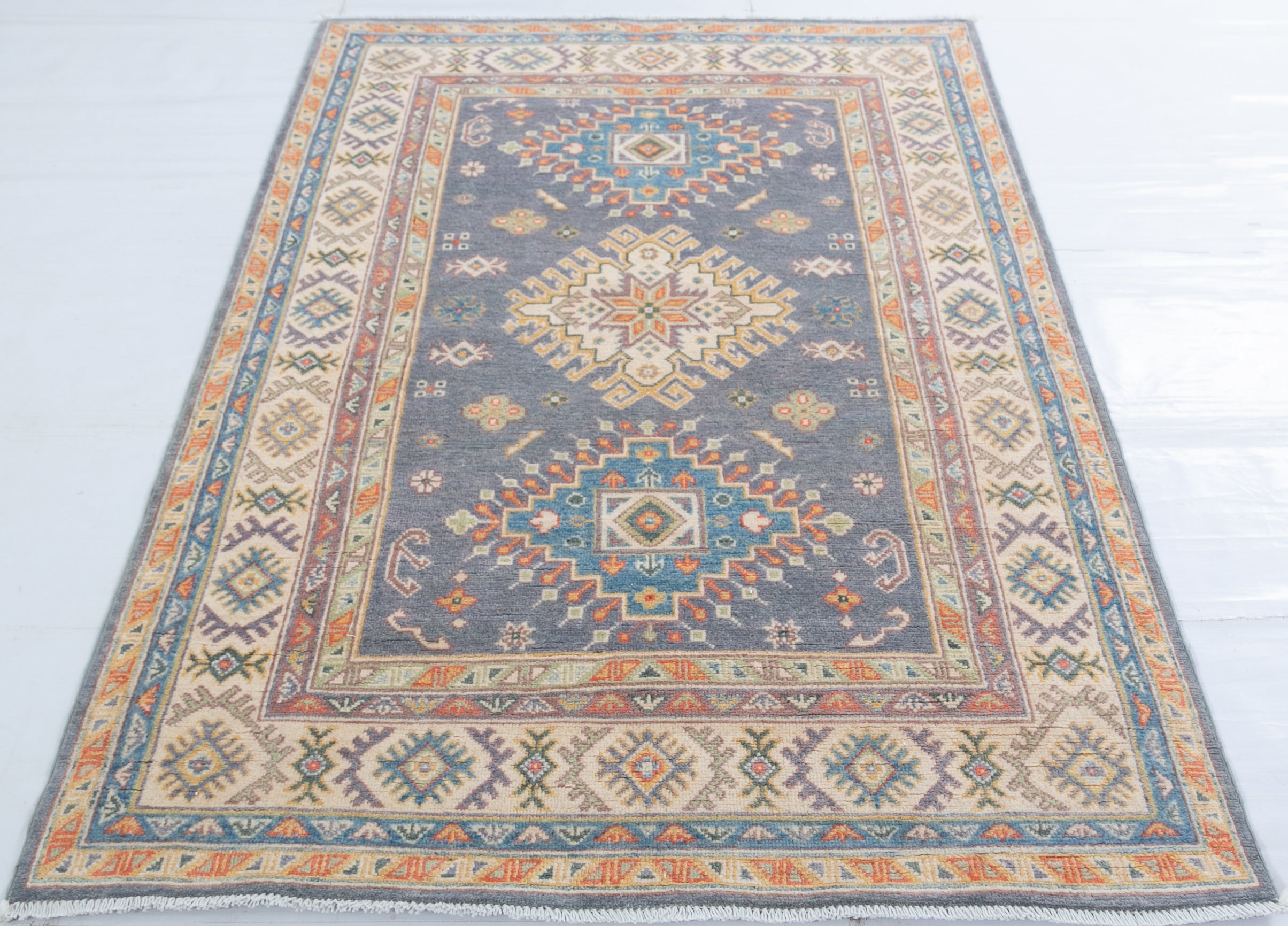Full view from a low angle of blue & ivory Kazak-inspired wool rug 26753.