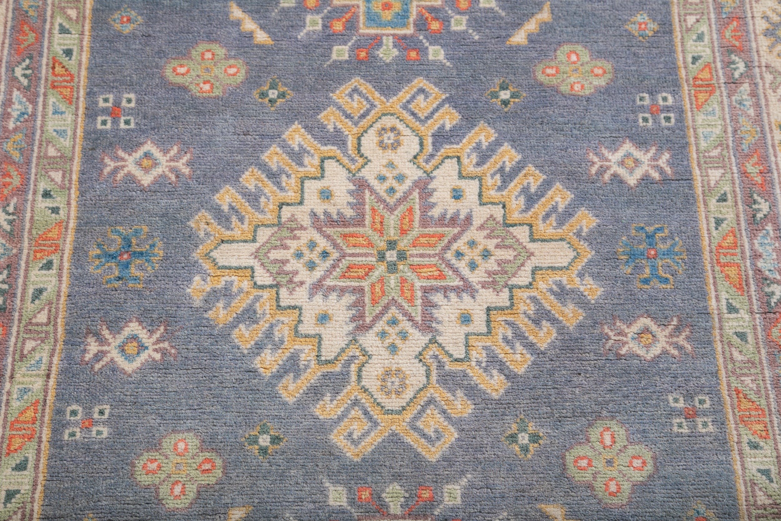 Pattern detail of blue & ivory Kazak-inspired wool rug 26753.