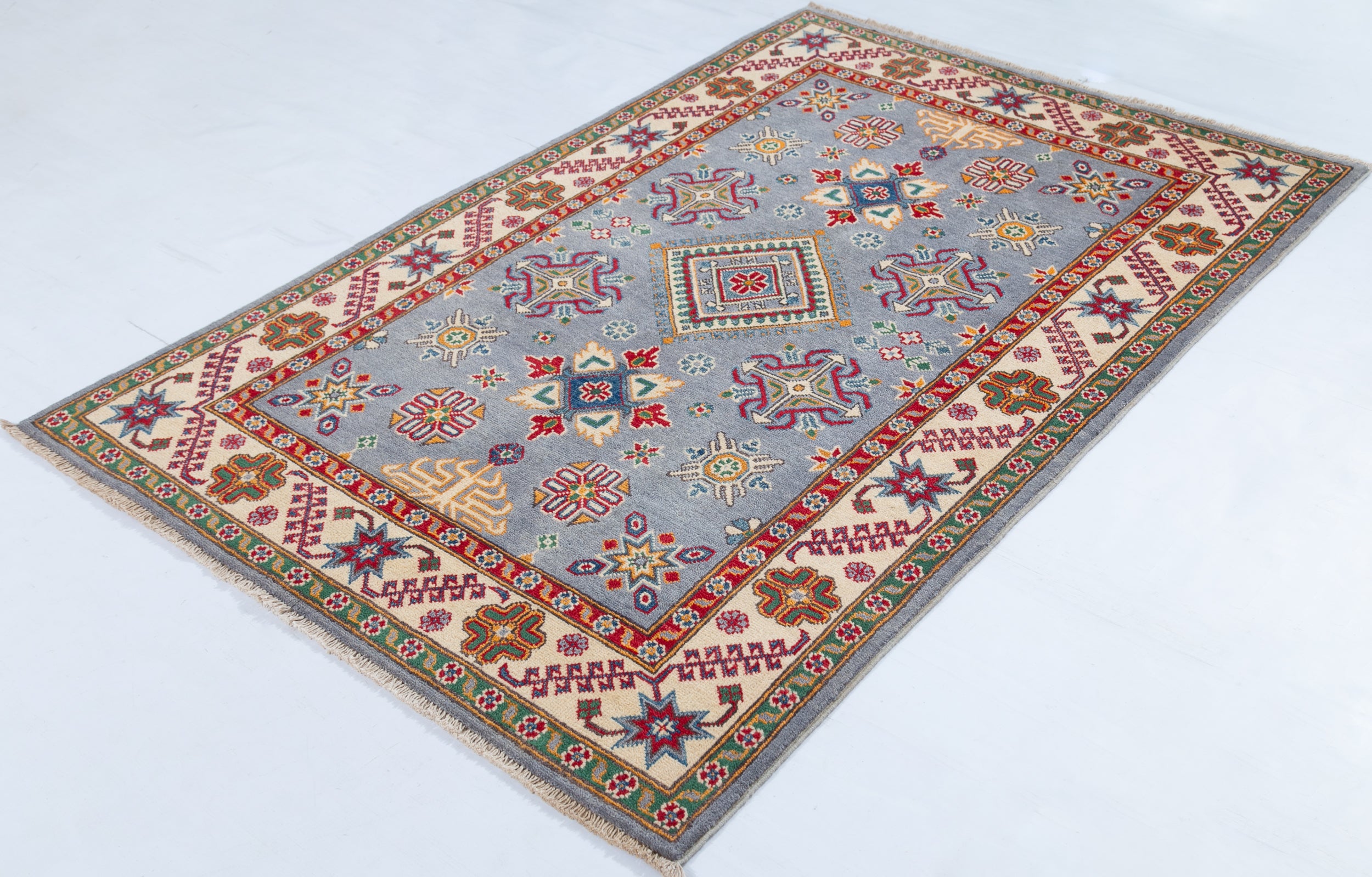 Full view at an angle of blue & red Kazak-inspired wool rug 27430.