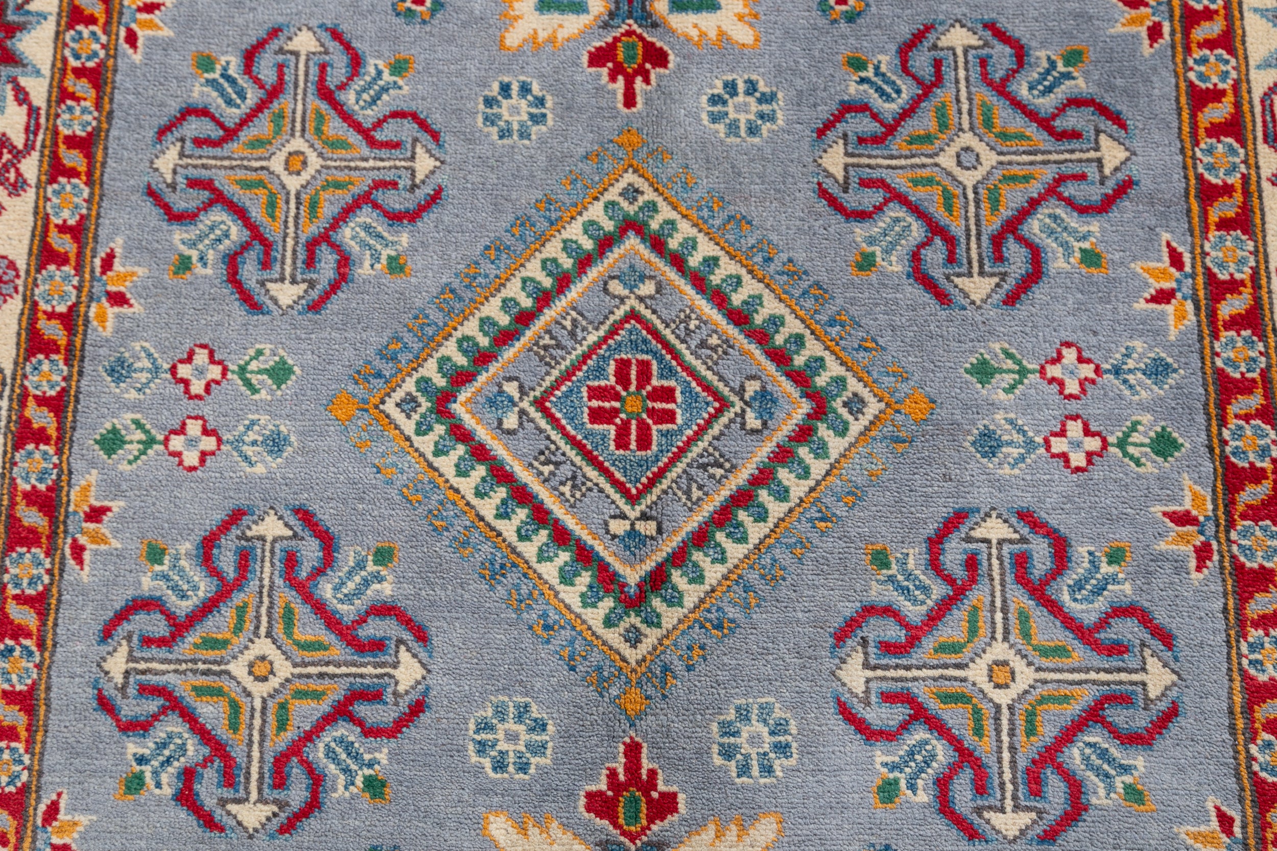 Pattern detail of blue & red Kazak-inspired wool rug 27430.