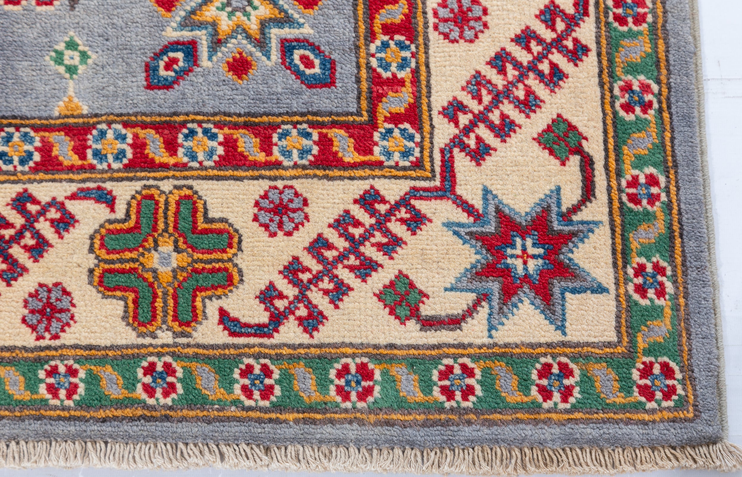 Border and edge detail of blue & red Kazak-inspired wool rug 27430.