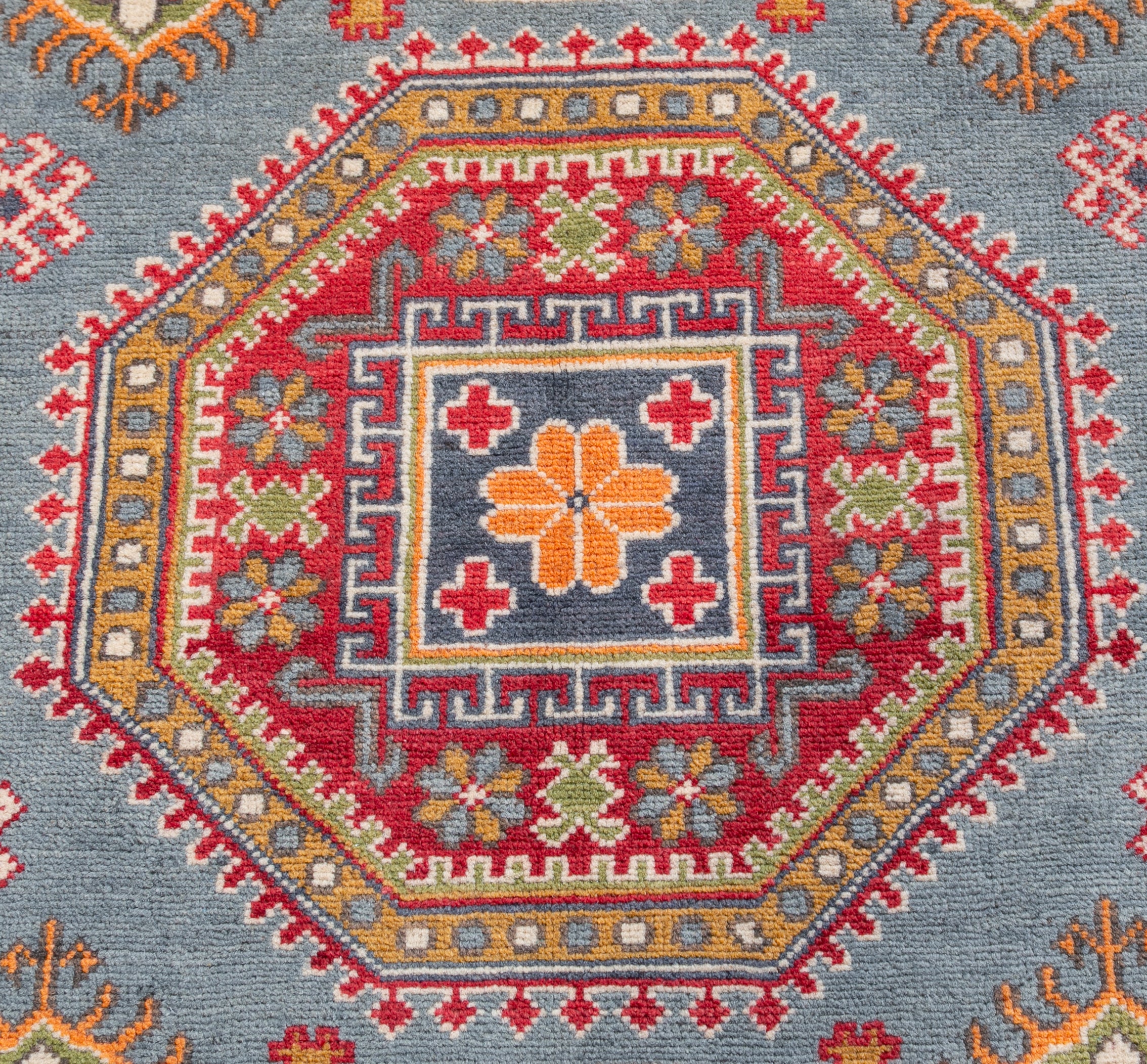 Pattern detail of blue & red Kazak-inspired wool rug 27433.