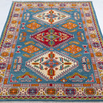 Full view from a low angle of blue & red Kazak-inspired wool rug 27434.