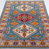 Full view from a low angle of blue & red Kazak-inspired wool rug 27434.