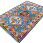 Full view at an angle of blue & red Kazak-inspired wool rug 27434.