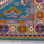 Border and edge detail of blue & red Kazak-inspired wool rug 27434.