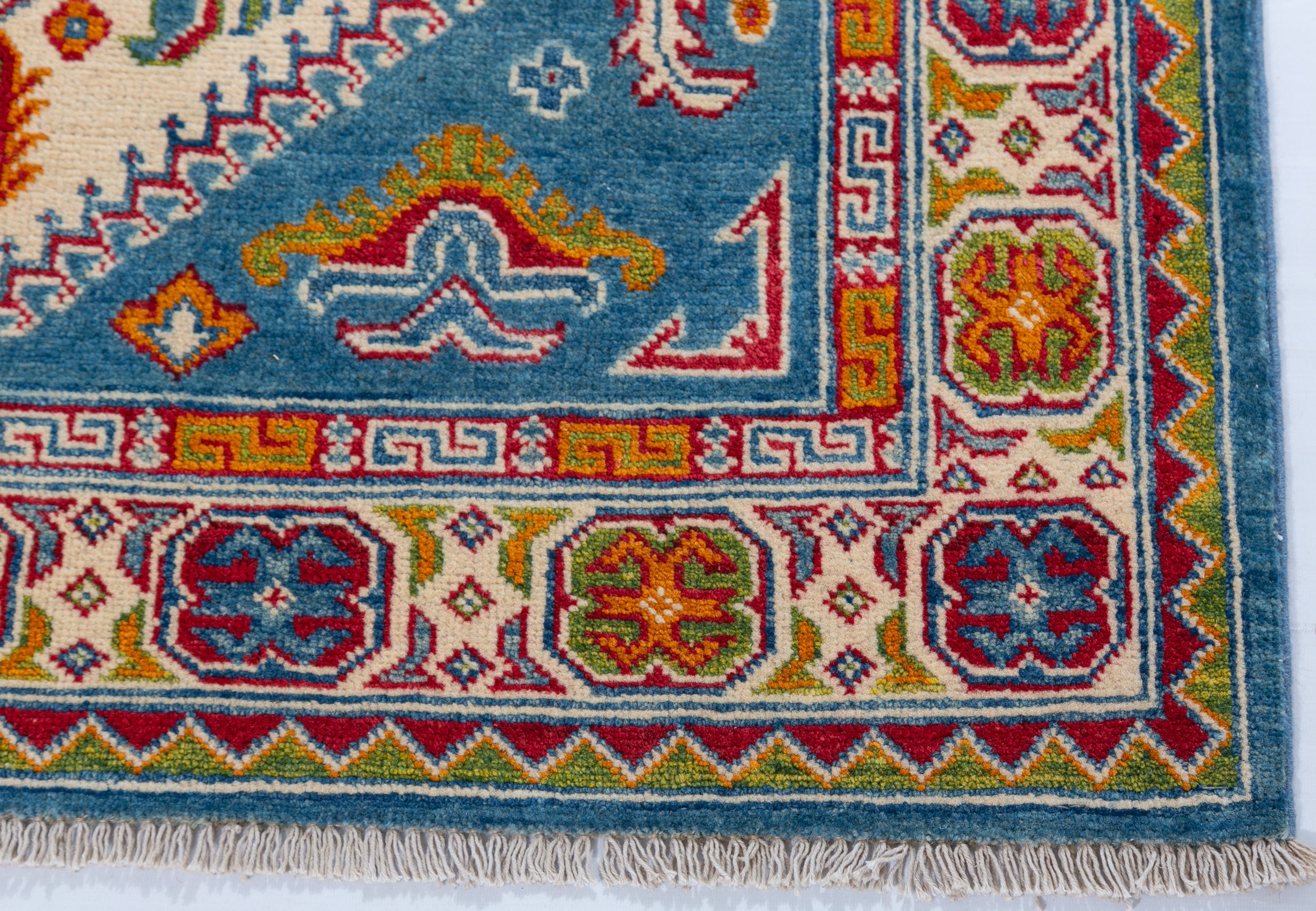 Border and edge detail of blue & red Kazak-inspired wool rug 27434.