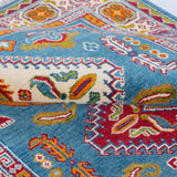 Folded edge and wool pile of blue & red Kazak-inspired wool rug 27434.