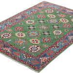 Full view at an angle of green & red Kazak-inspired wool rug 29347.
